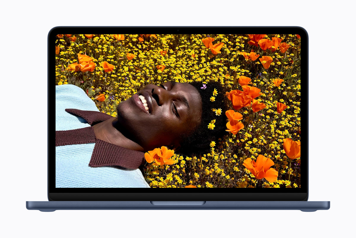 MacBook Neo 13-inch Indigo, front open with photo on screen